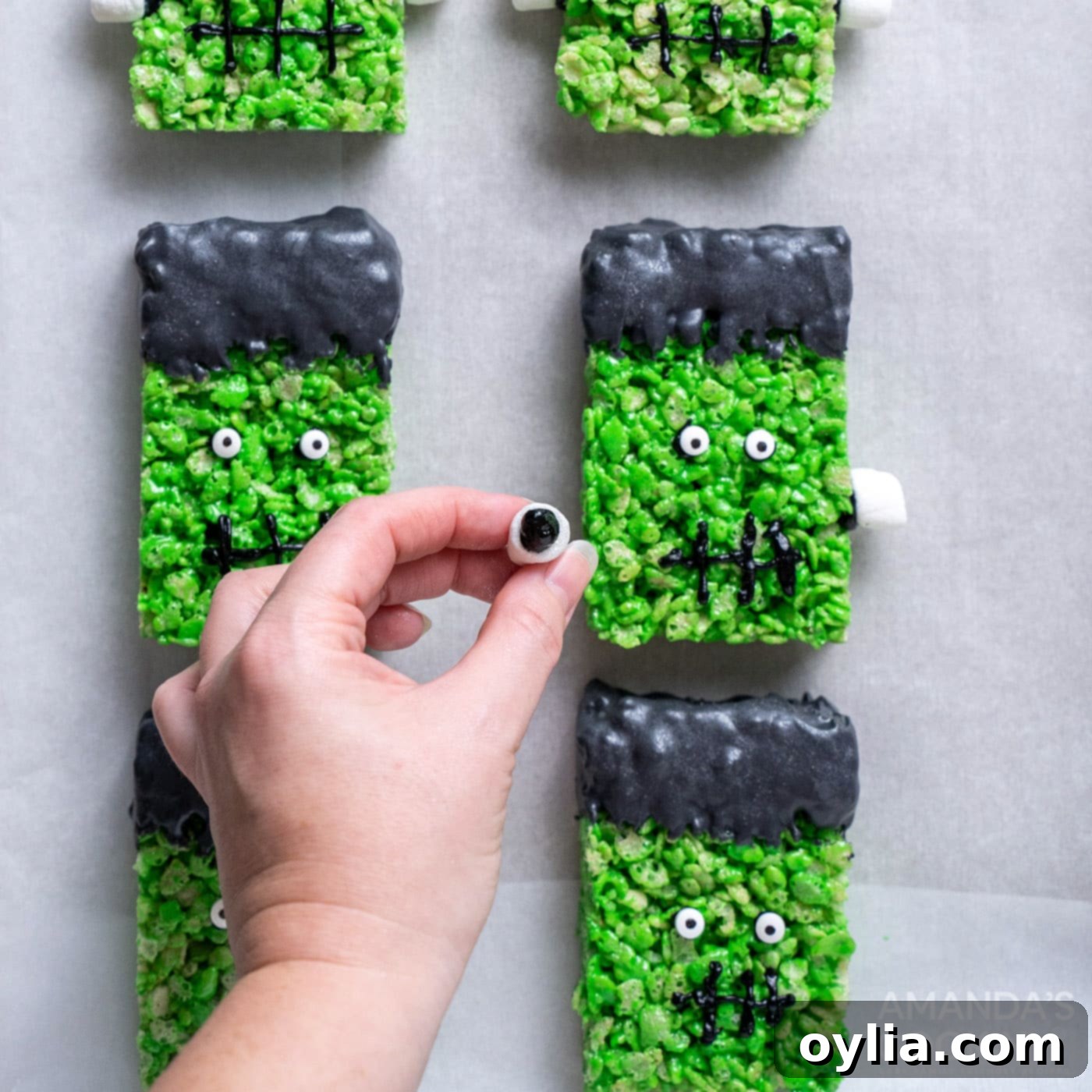 Monster Mash Krispie Treats 15 hand attaching mini marshmallows to frankenstein rice krispie treats