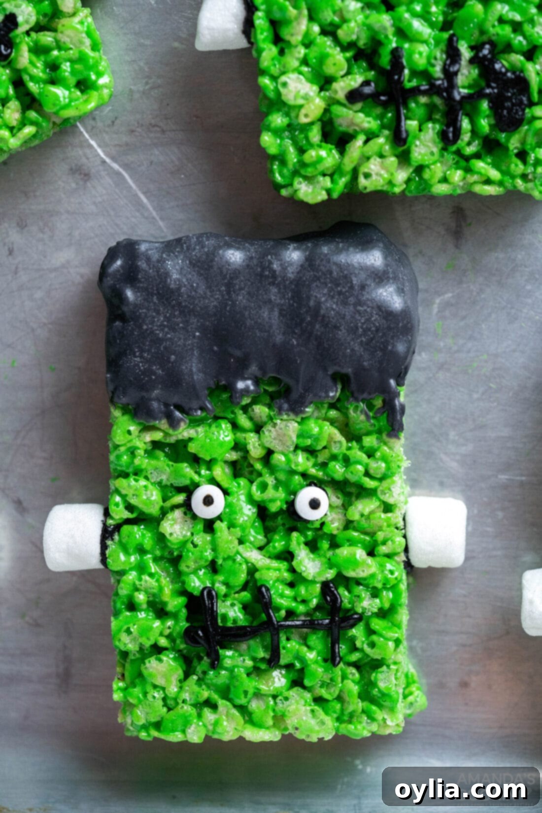 Monster Mash Krispie Treats 3 Frankenstein Rice Krispie Treats on a cookie sheet
