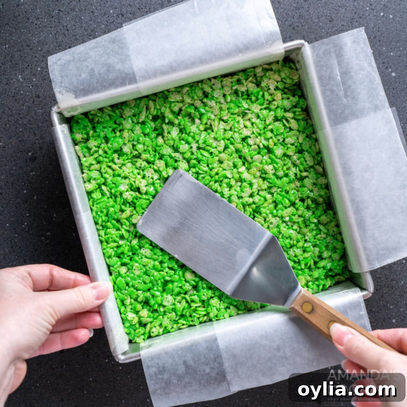 Monster Mash Krispie Treats 9 spatula patting flat rice krispie treats