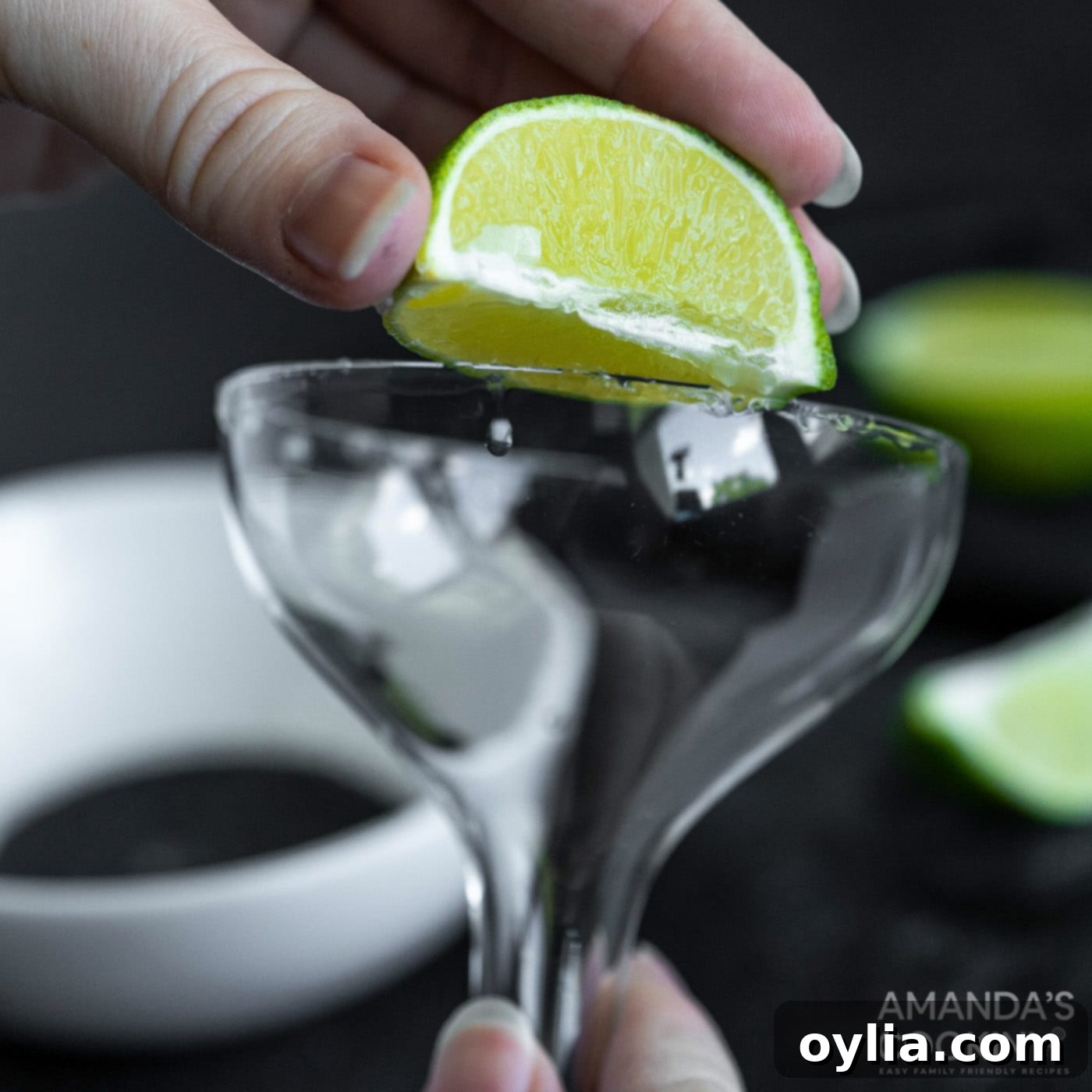 rubbing lime wedge on margarita glass