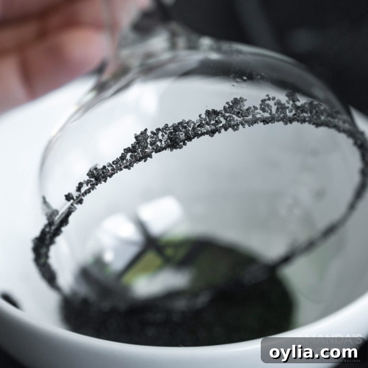 dipping margarita glass in black salt