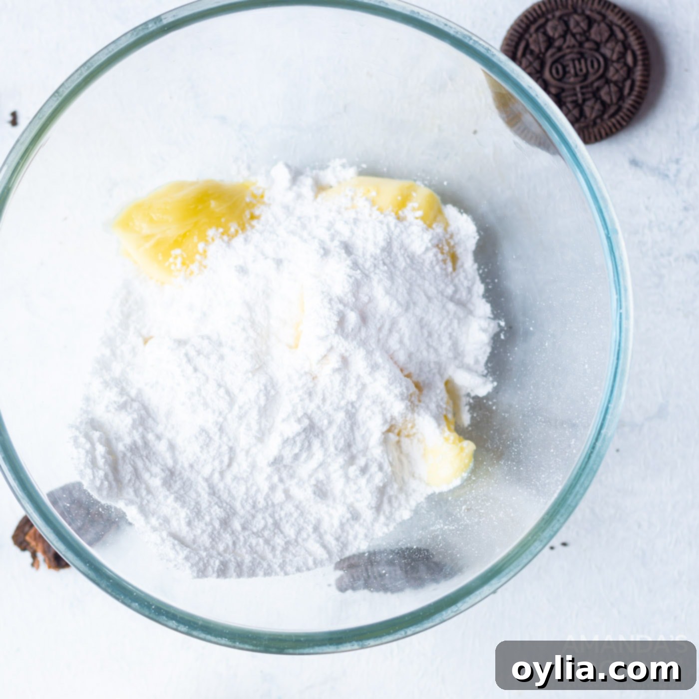 butter with powdered sugar in a bowl