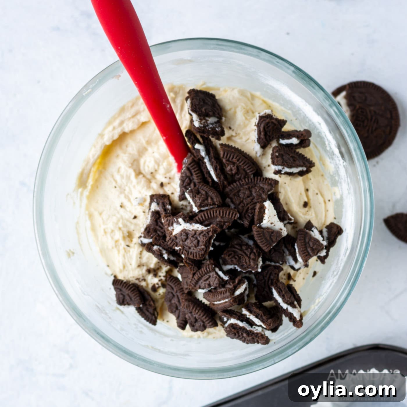 cupcake batter with crushed oreos in a mixing bowl