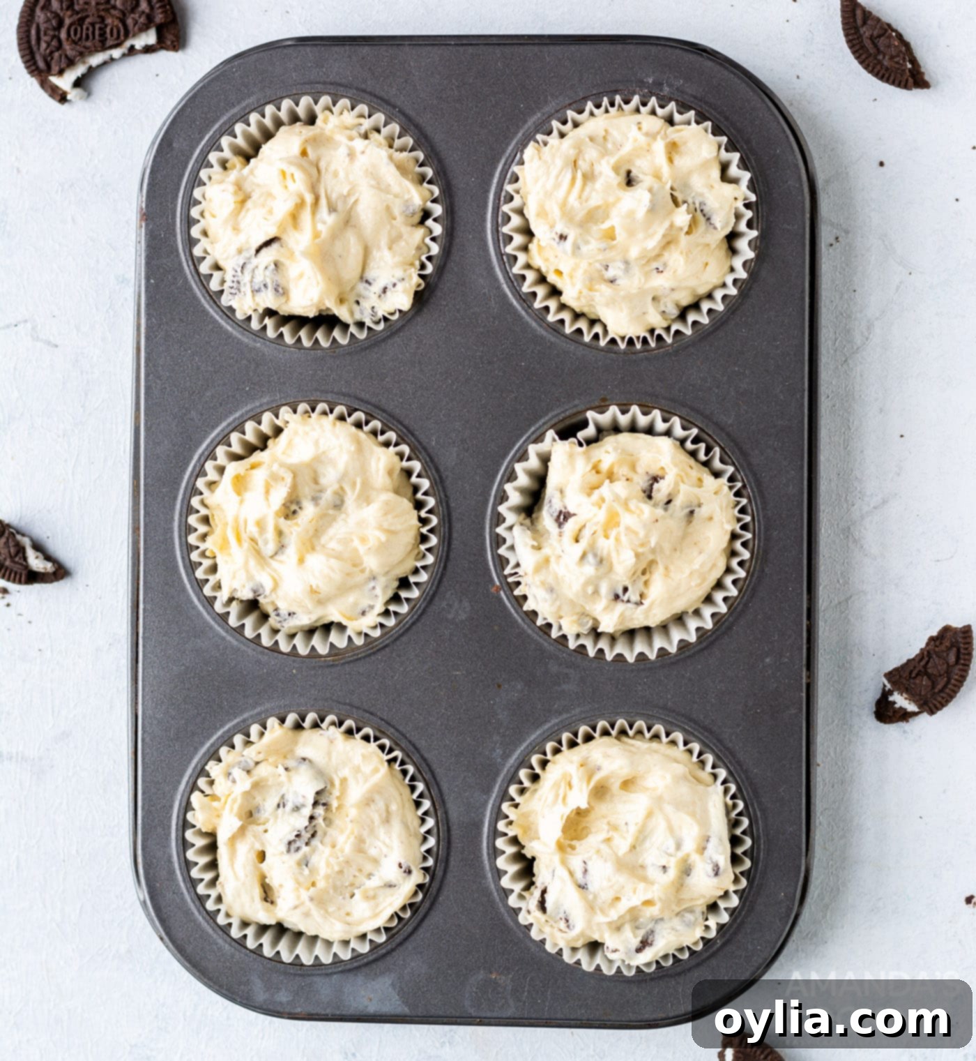 oreo cupcake batter in a cupcake tin