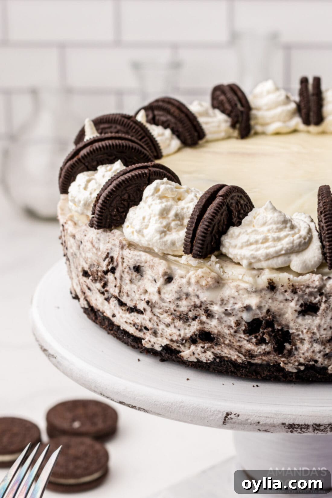 Oreo Cheesecake on a cake plate, a perfect dessert for any occasion.