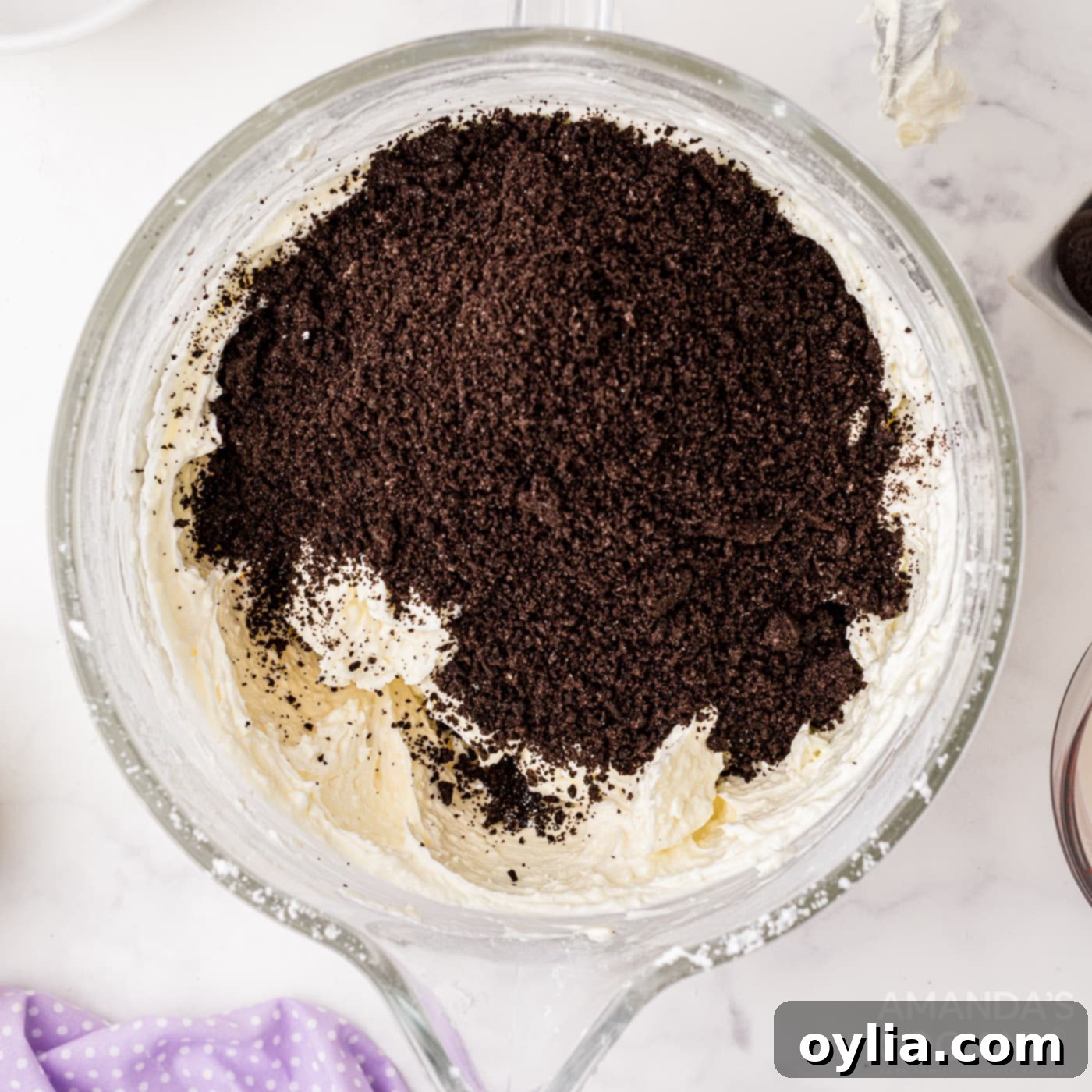 Roughly crushed Oreo pieces stirred into the creamy cheesecake mixture.