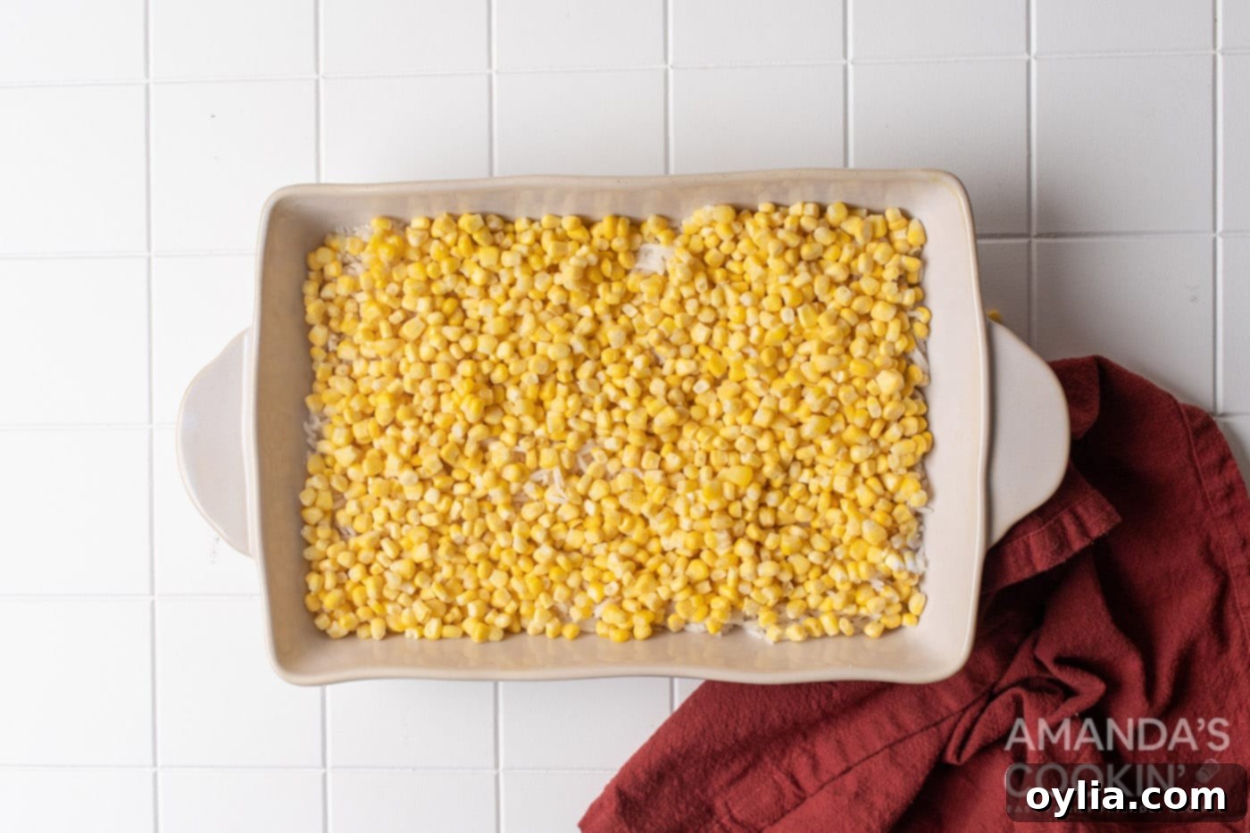 Stacked Supper Supreme 6 corn on top of rice in casserole dish