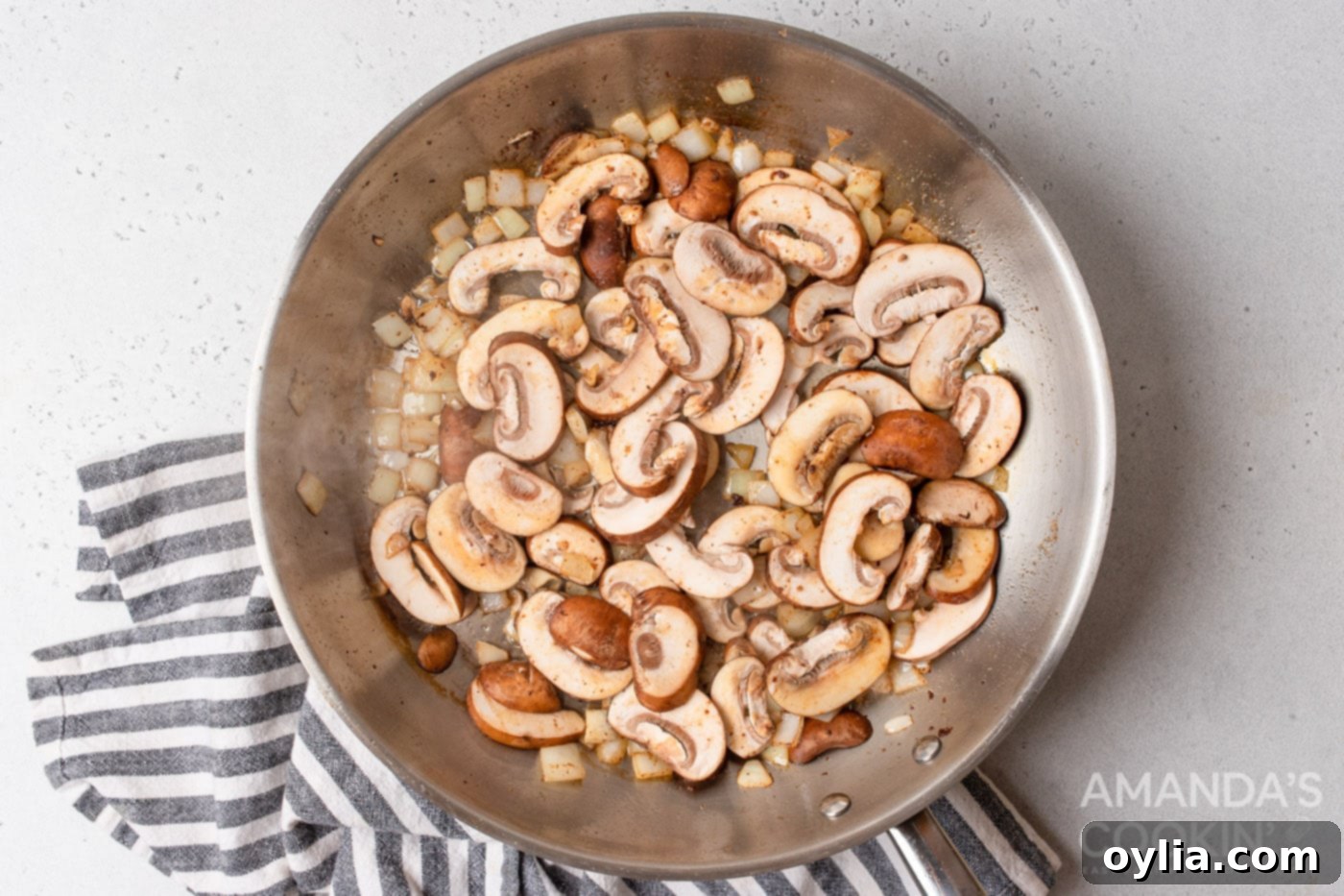 mushrooms and onions in a skillet