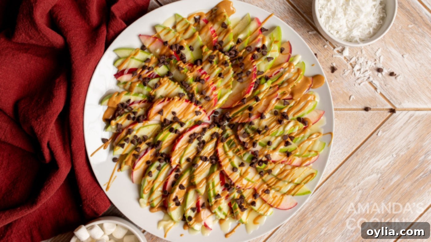 Close-up of fully topped Apple Nachos with peanut butter, chocolate chips, and more