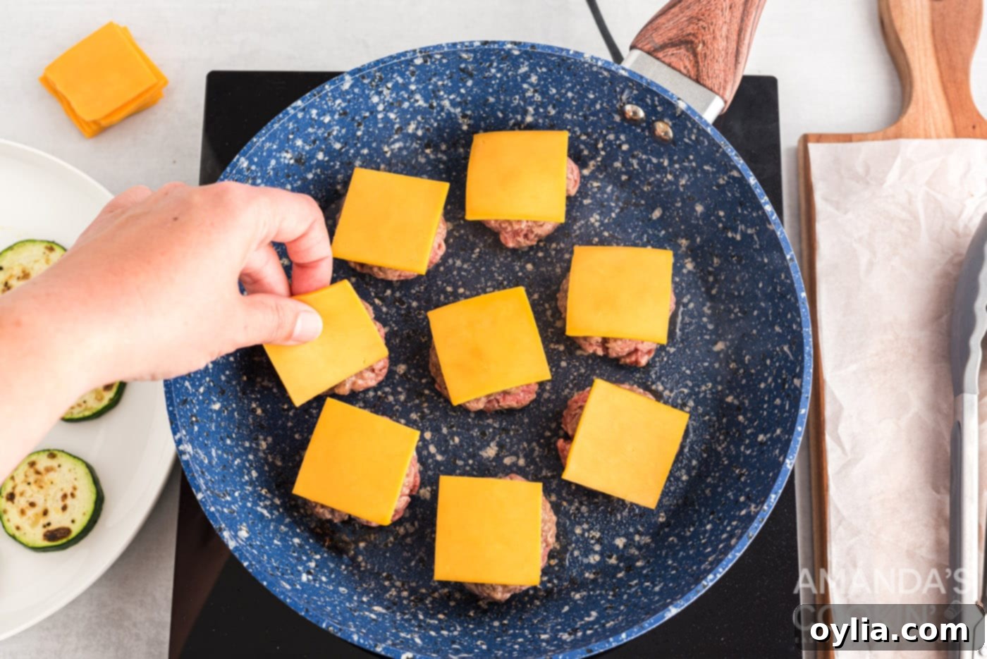 mini cheeseburgers in a skillet