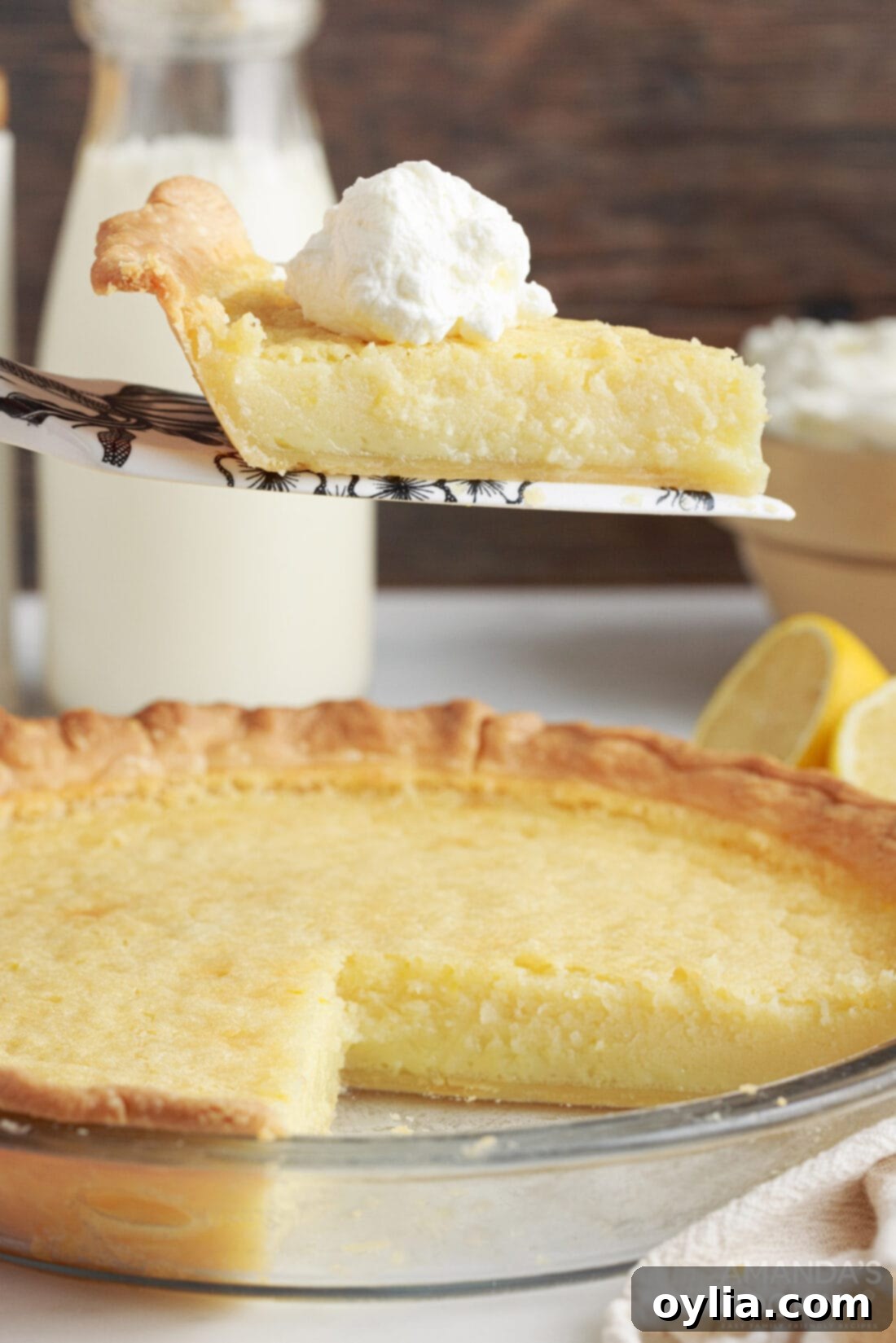 slice of Southern Buttermilk Pie being removed from pan