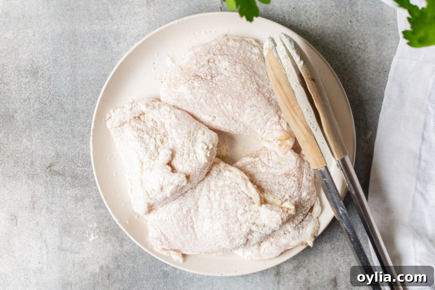 flour coated chicken breasts ready for pan-frying