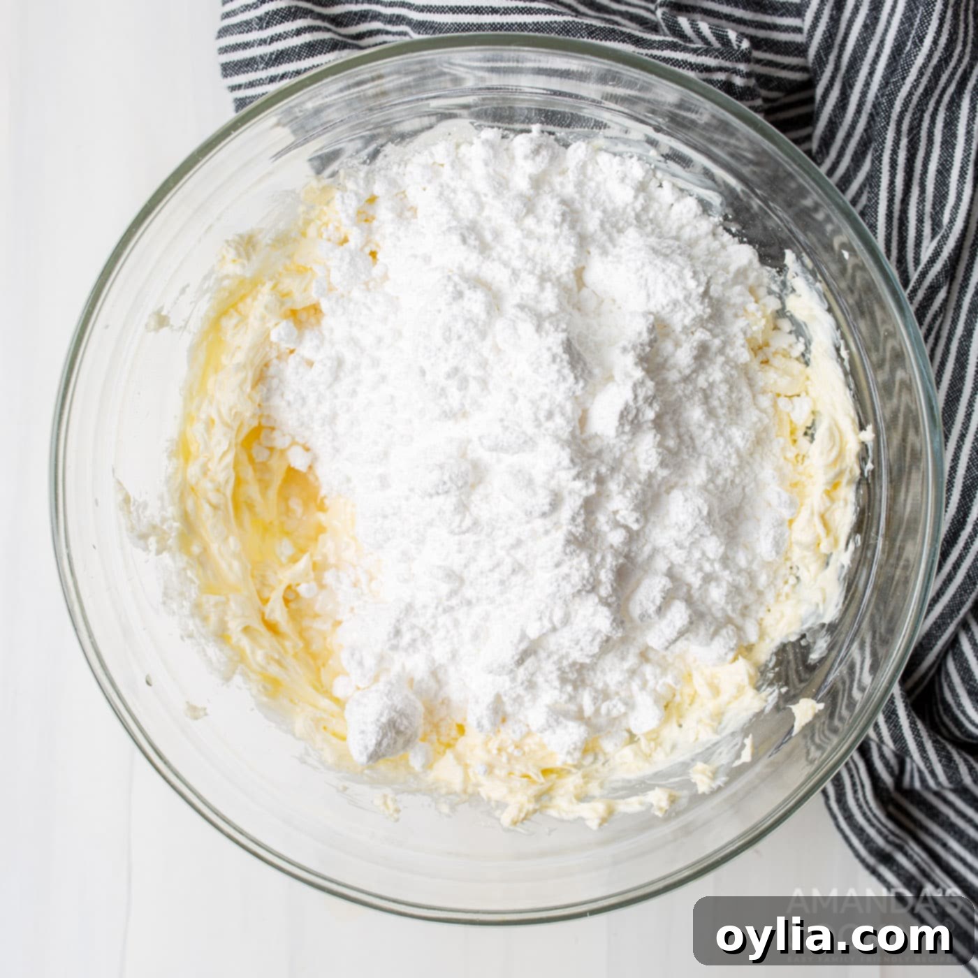 Cream cheese, butter, and powdered sugar being mixed in a bowl for the frosting.