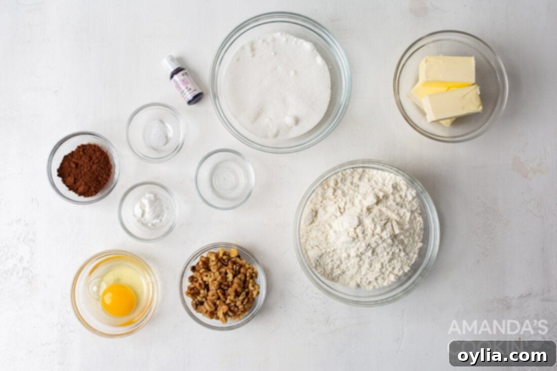 All the necessary ingredients laid out on a table for making Neapolitan cookies.