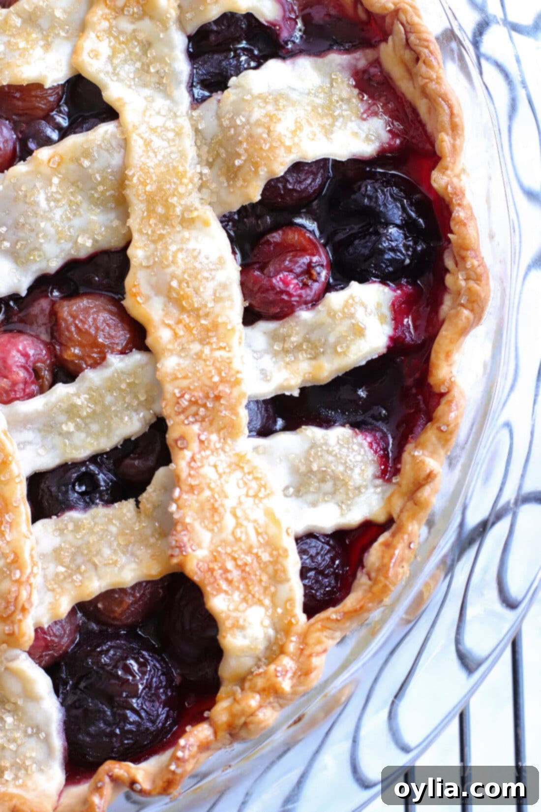 An overhead view of the whole baked homemade bourbon cherry pie with its beautiful lattice crust.