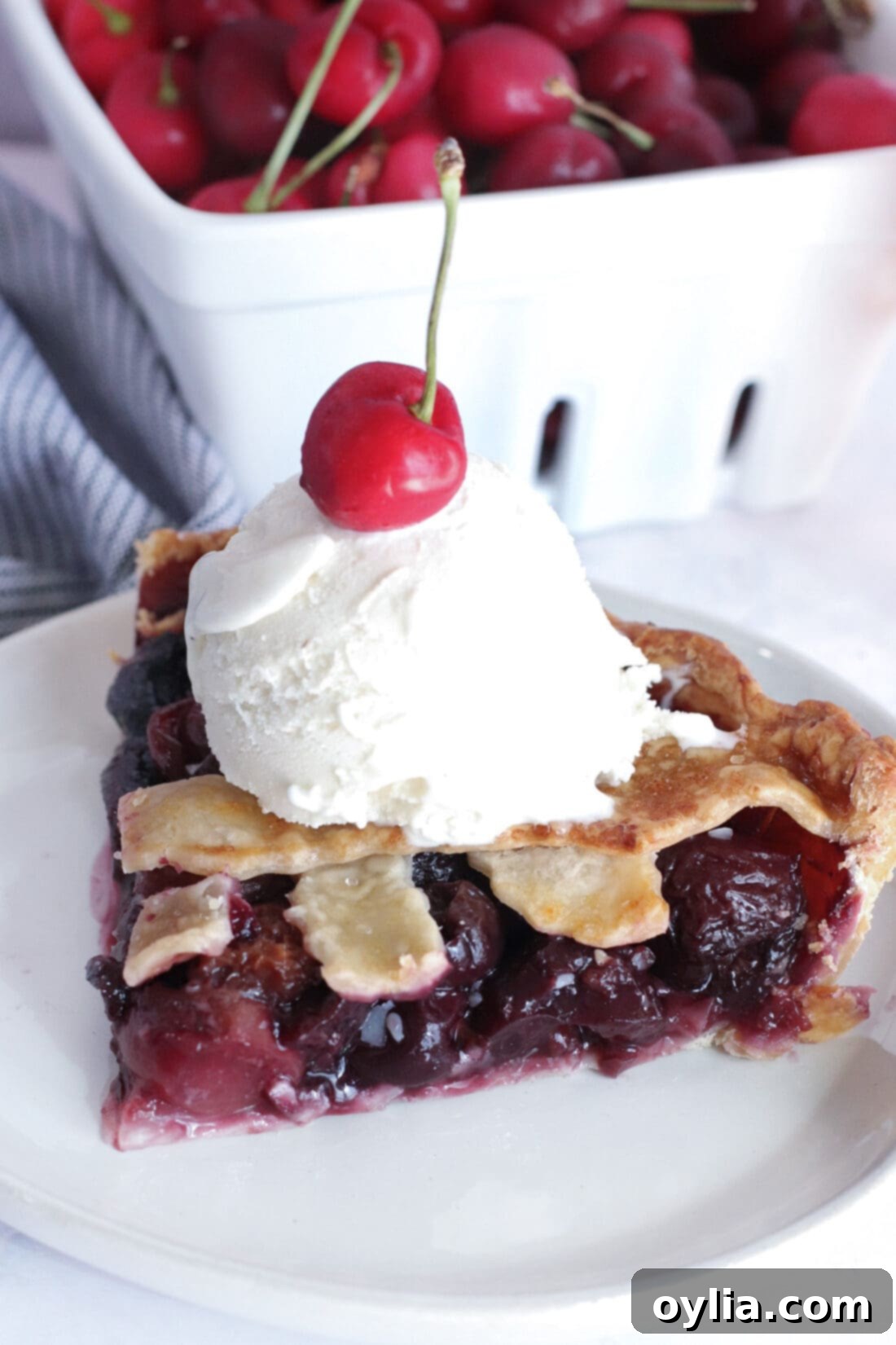 A beautiful slice of homemade bourbon cherry pie, showcasing the vibrant filling and flaky lattice crust.