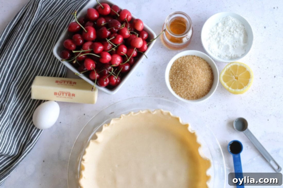 All the essential ingredients for making homemade cherry pie laid out on a kitchen counter.
