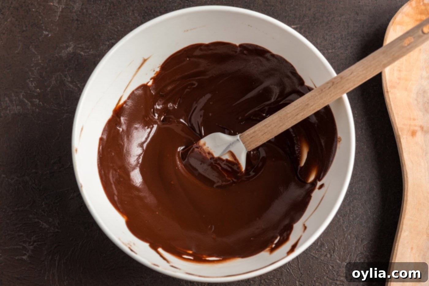 melted chocolate in a bowl with a rubber spatula