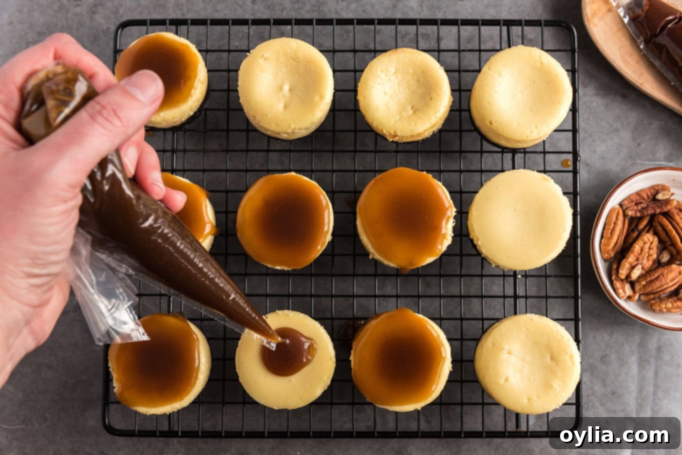 pooling caramel over mini cheesecakes