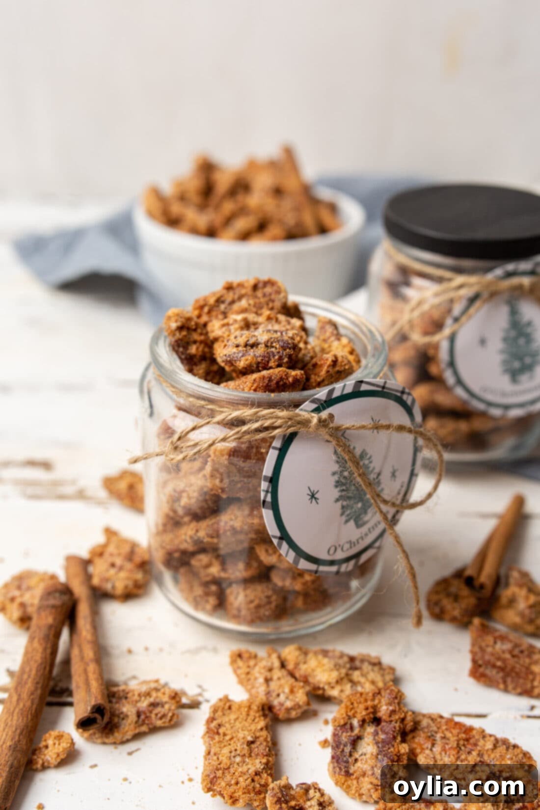 Jar of perfectly cinnamon sugar coated candied pecans, ready for gifting or snacking.