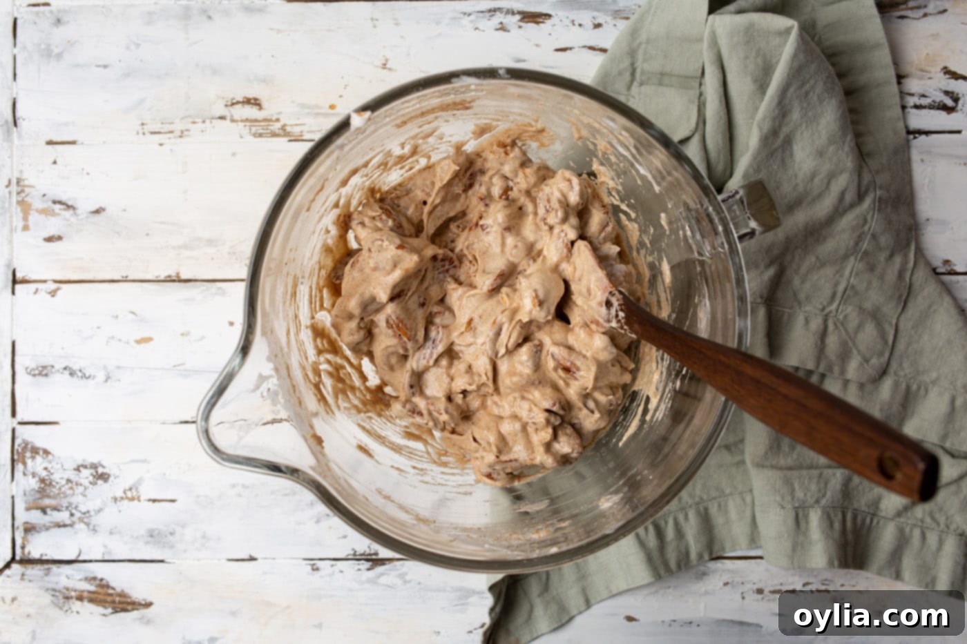 Pecans thoroughly mixed with a cinnamon sugar coating in a bowl.