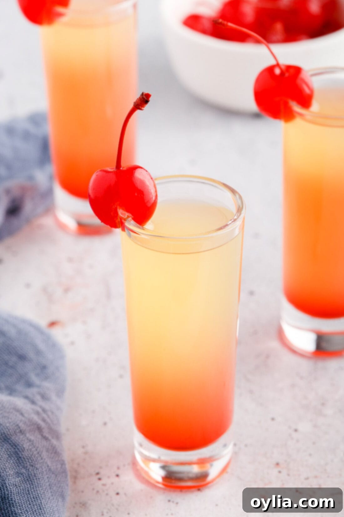 Pineapple Upside Down Cake Shot garnished with a cherry