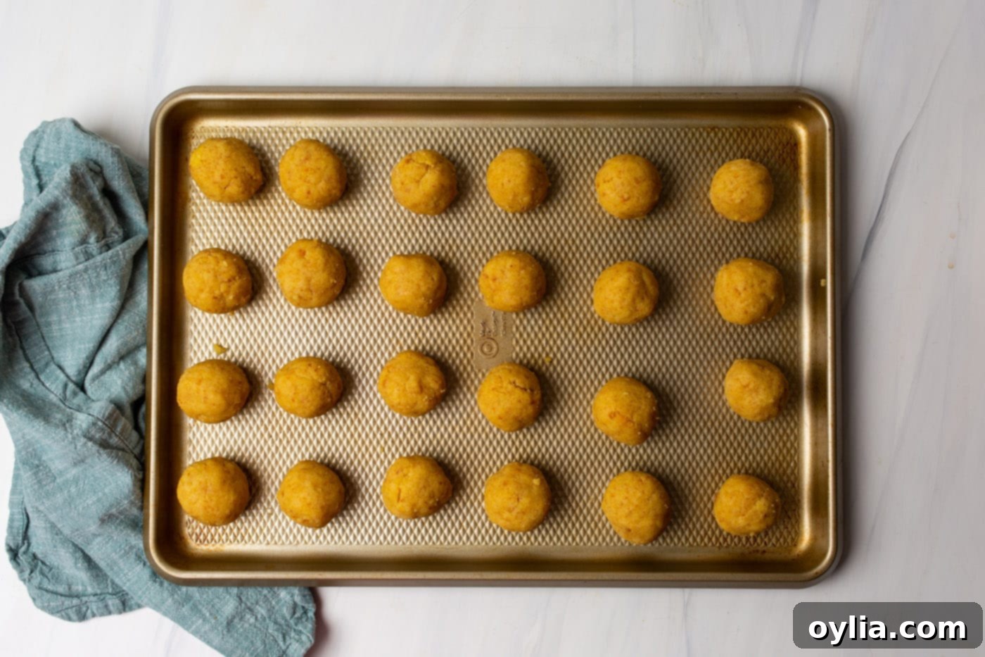 Evenly rolled cake balls on a baking sheet, ready for chilling