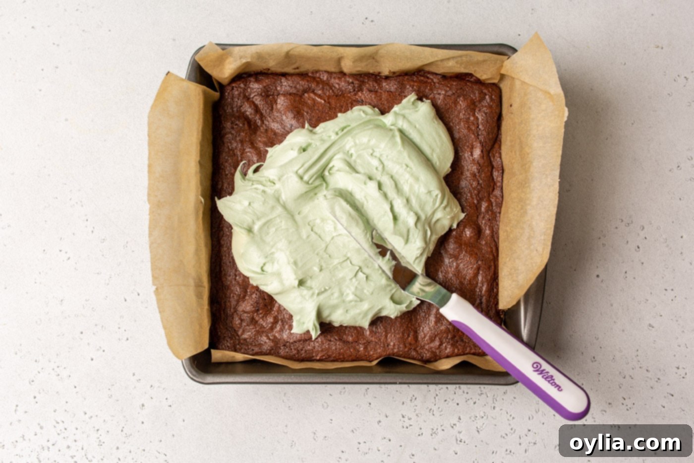 mint frosting spread onto brownies