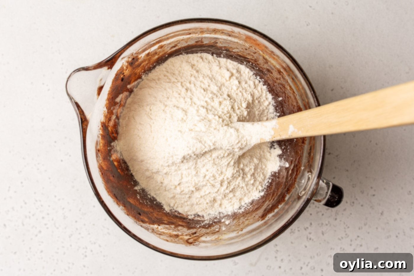 bowl of chocolate brownie batter with flour