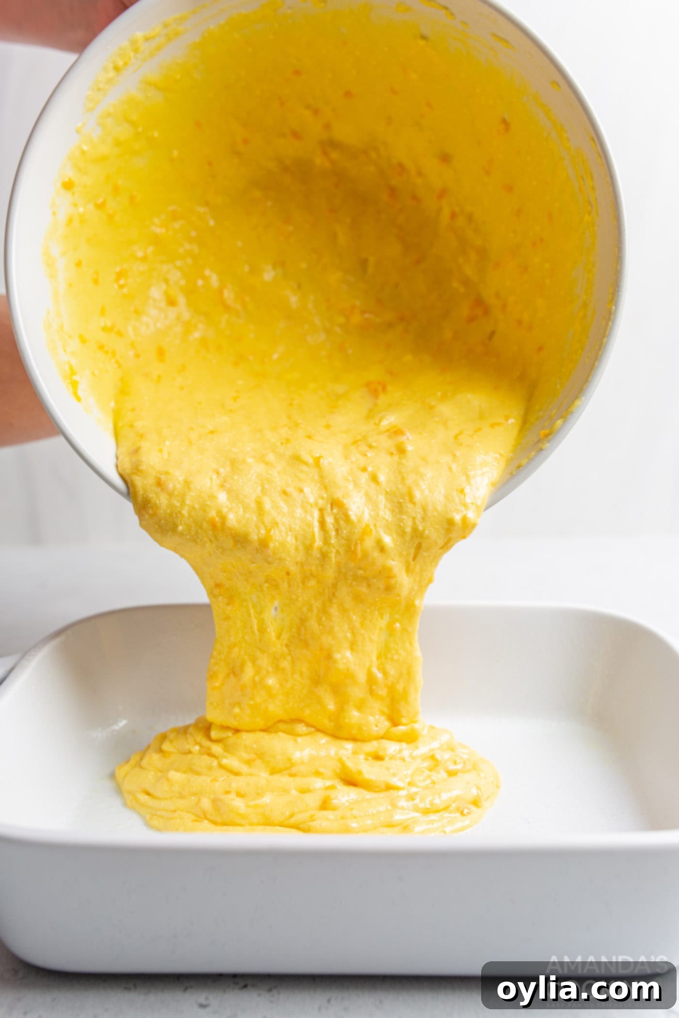 pouring cake mix into pan