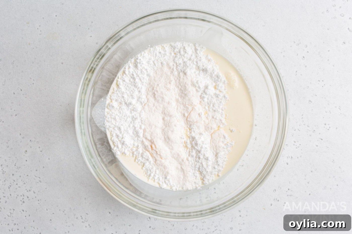 heavy whipping cream, powdered sugar, and vanilla pudding mix in a mixing bowl