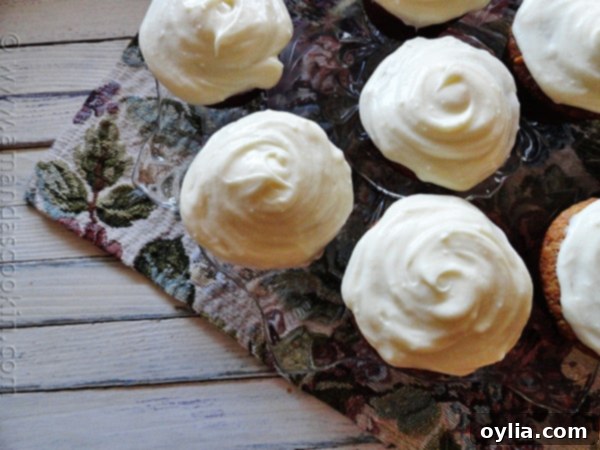 An overhead photo of banana cupcakes with vanilla cream cheese frosting, elegantly arranged and ready to be served.