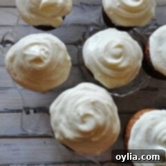 An overhead photo of banana cupcakes with vanilla cream cheese frosting.