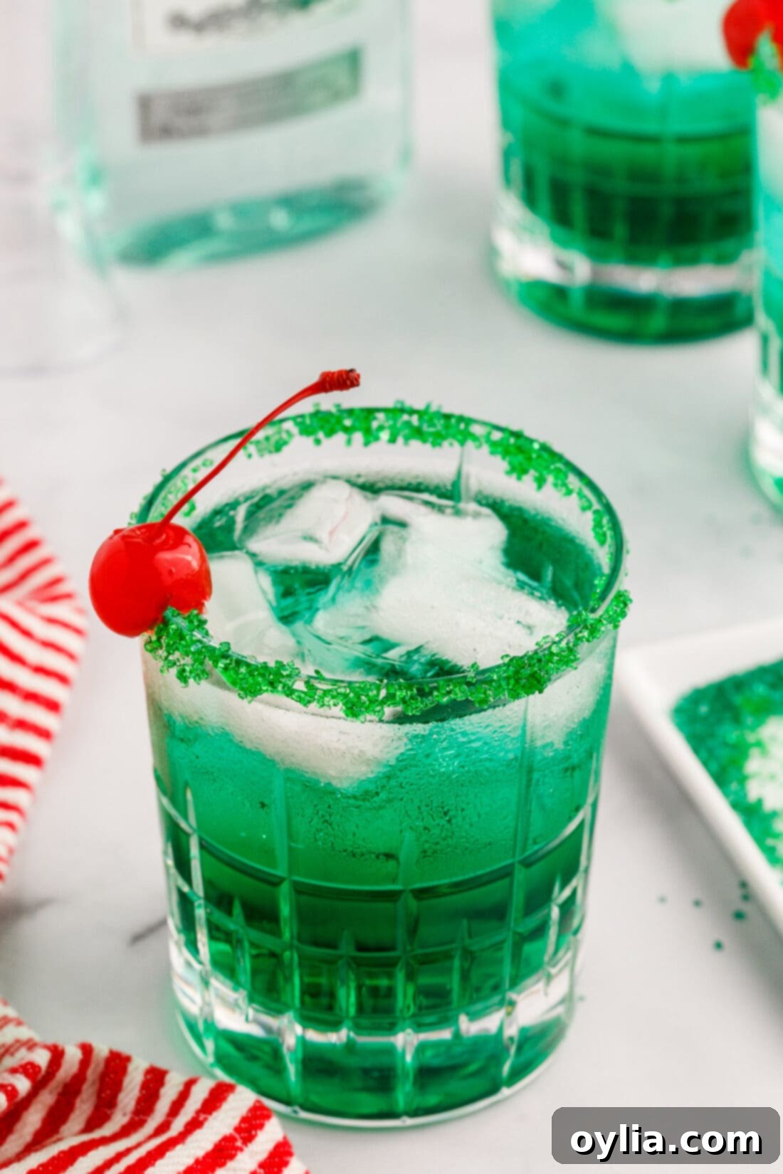 Close-up of the vibrant green Grinch Cocktail with a sugared rim