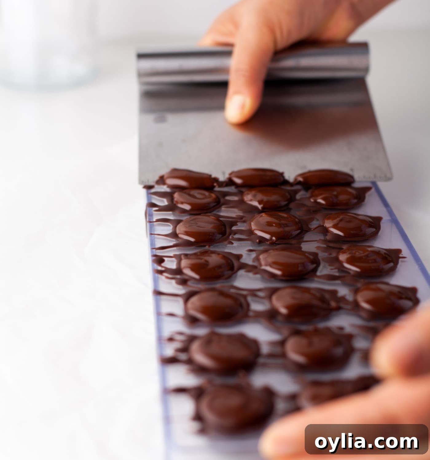 scraping chocolate off of candy mold