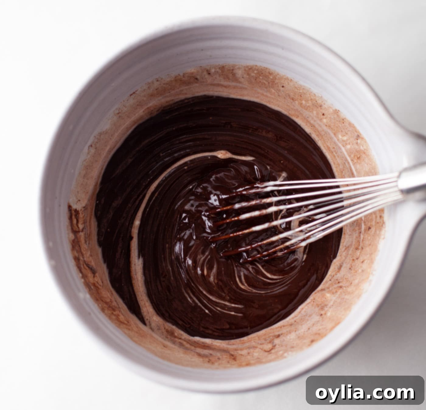 whisking together whipping cream and melted chocolate