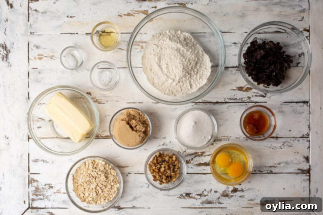 various baking ingredients for oatmeal raisin cookies laid out on a table