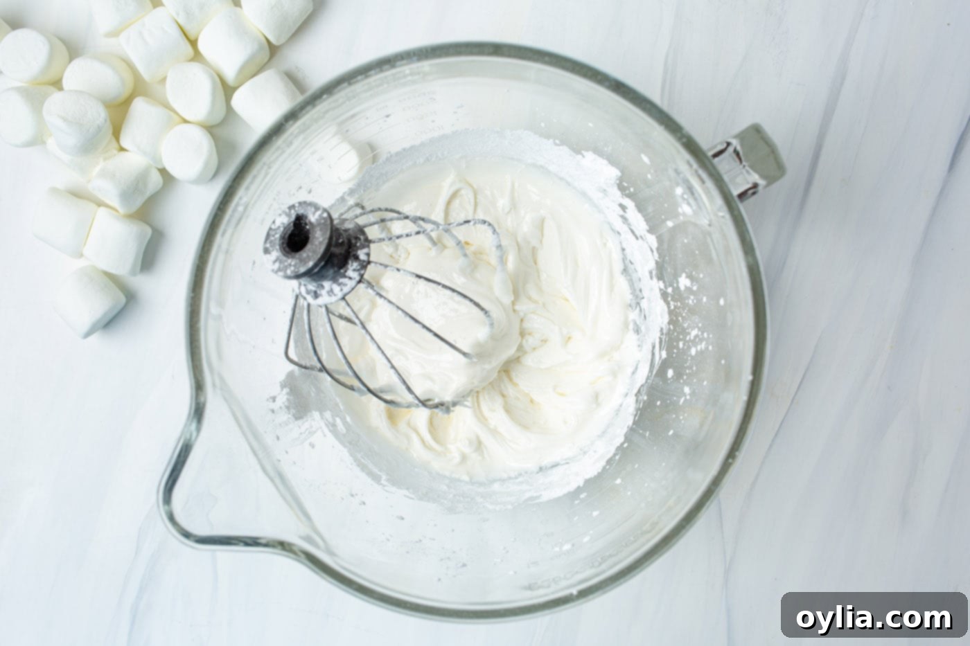 egg whites, vanilla, and powdered sugar in a stand mixer bowl