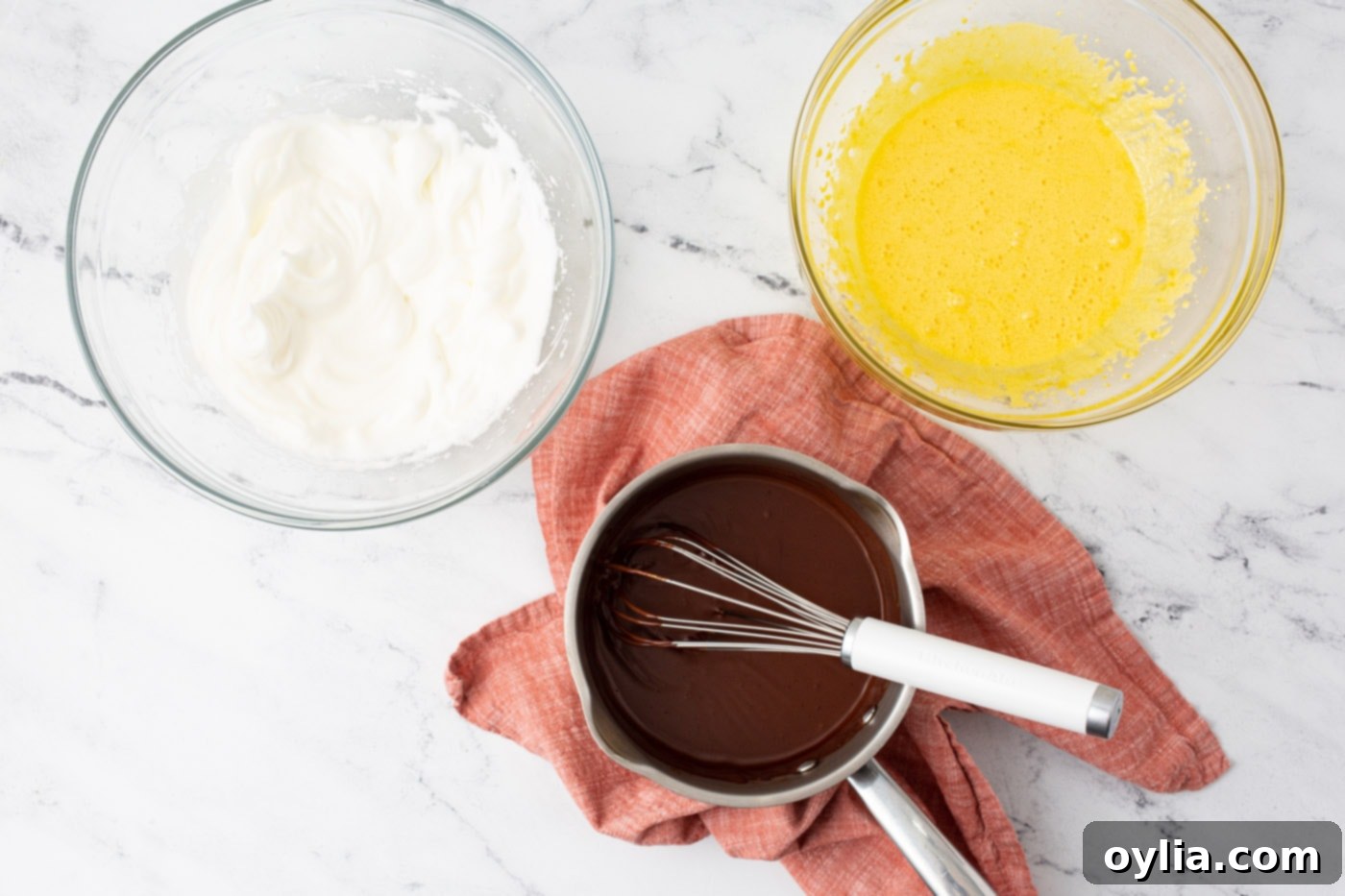 Velvety Chocolate Dream 6 chocolate ganache, whisked egg yolks, and beaten egg whites in bowls
