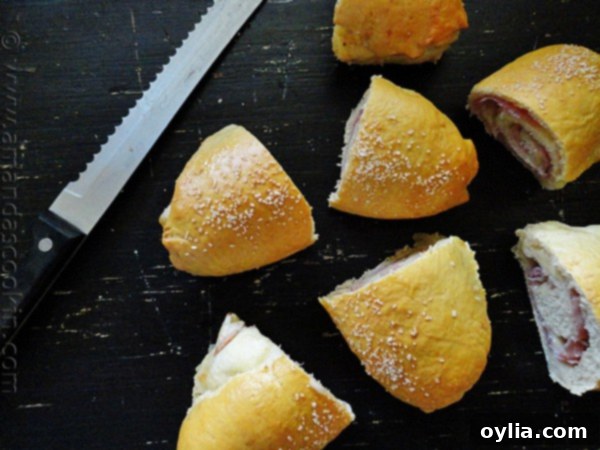 Cross-section of Ham & Cheese Pretzel Roll Sandwiches, showcasing melted cheese and ham