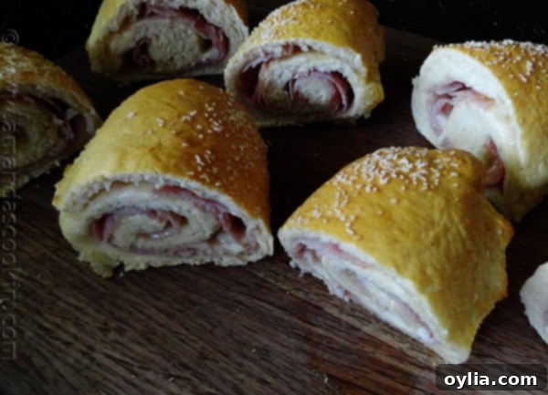 Opened Ham & Cheese Pretzel Roll Sandwiches revealing cheesy goodness