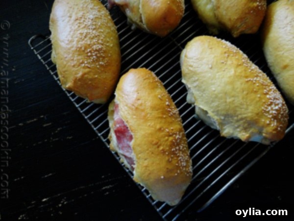 Freshly baked Ham & Cheese Pretzel Rolls cooling on a rack