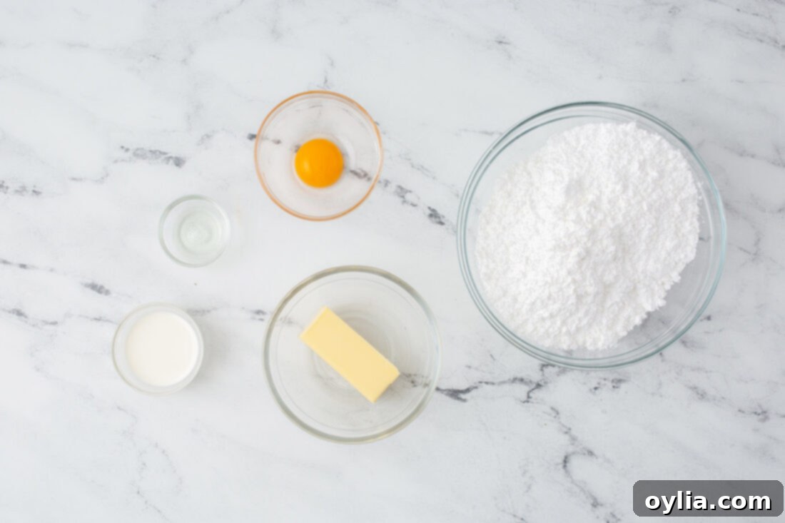 Ingredients for creamy lemon buttercream frosting, including butter, powdered sugar, and lemons.