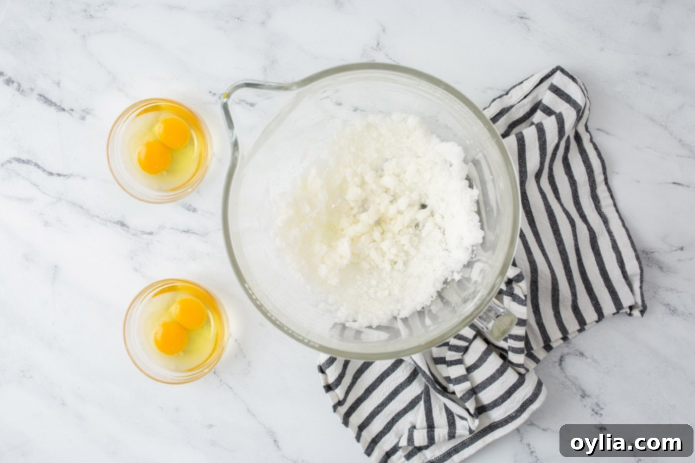 Creaming shortening and sugar together in a stand mixer bowl, the first step for the lemon cake batter.
