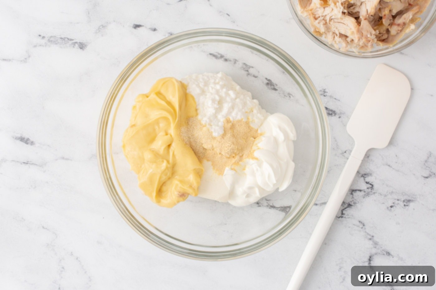 cream cheese, cottage cheese, sour cream, and cream of chicken soup in a mixing bowl