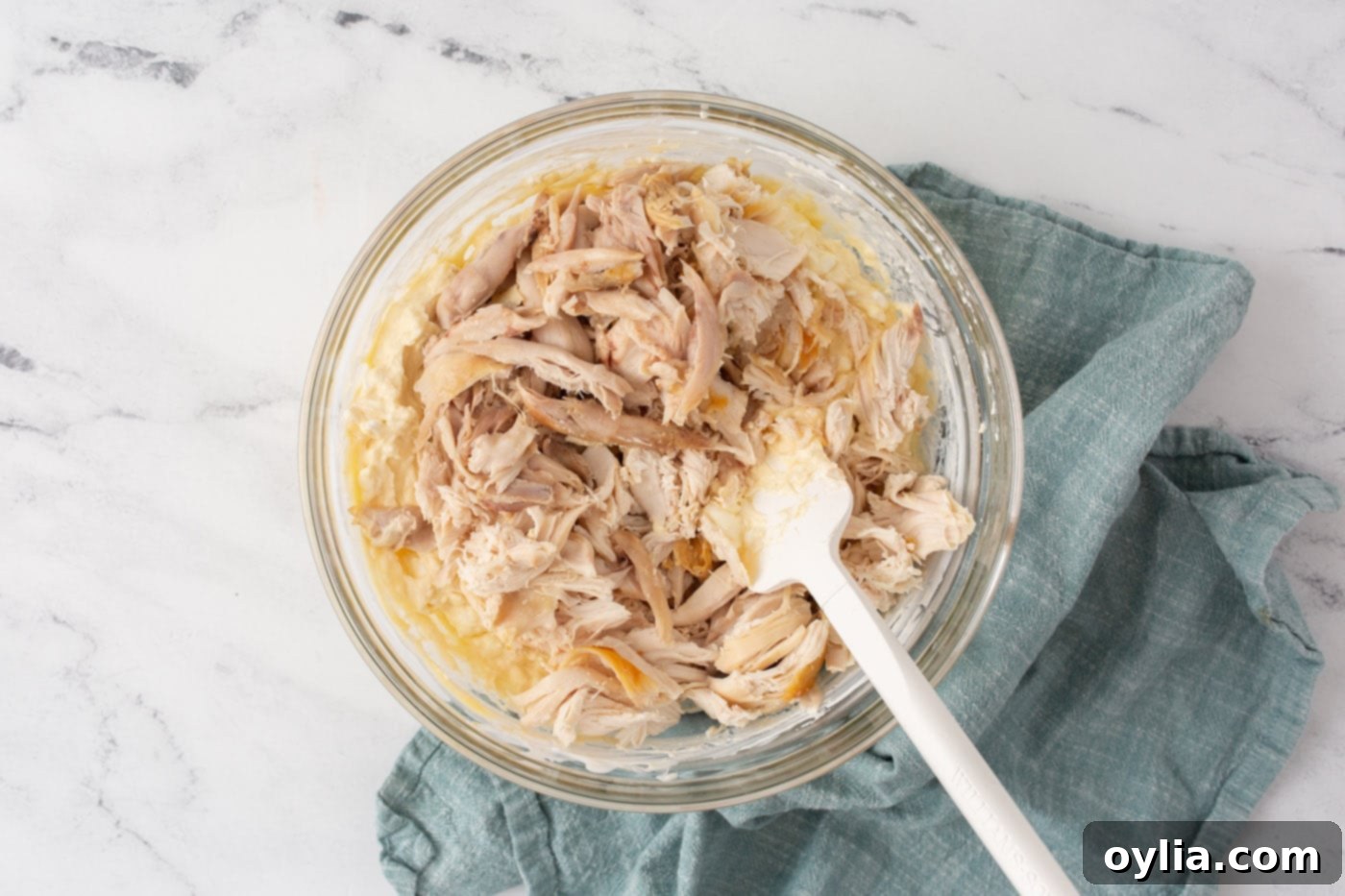 Stirring chicken into cream cheese mixture