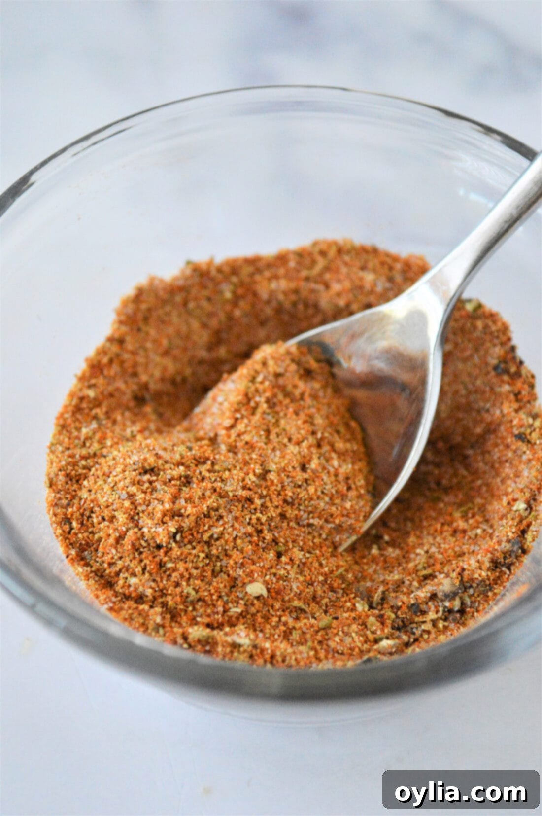 A flavorful blend of homemade French Fry Seasoning in a bowl with a spoon, ready to be used on delicious meals.