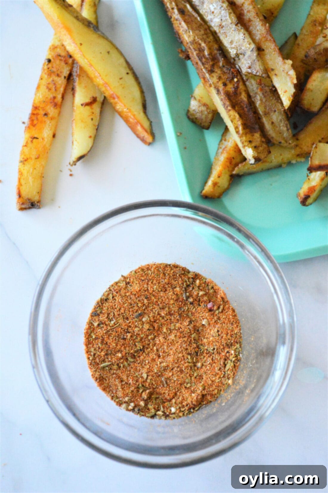 A closer look at the delicious blend of French Fry Seasoning in a small white bowl.