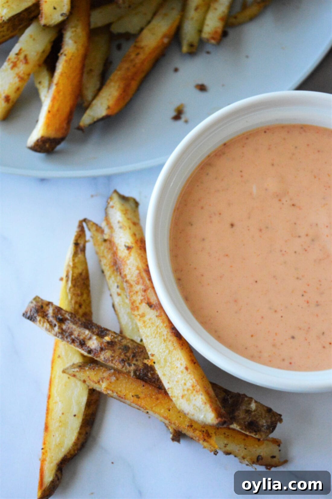 Homemade French Fry Sauce in a small white dish, garnished with a sprinkle of paprika.