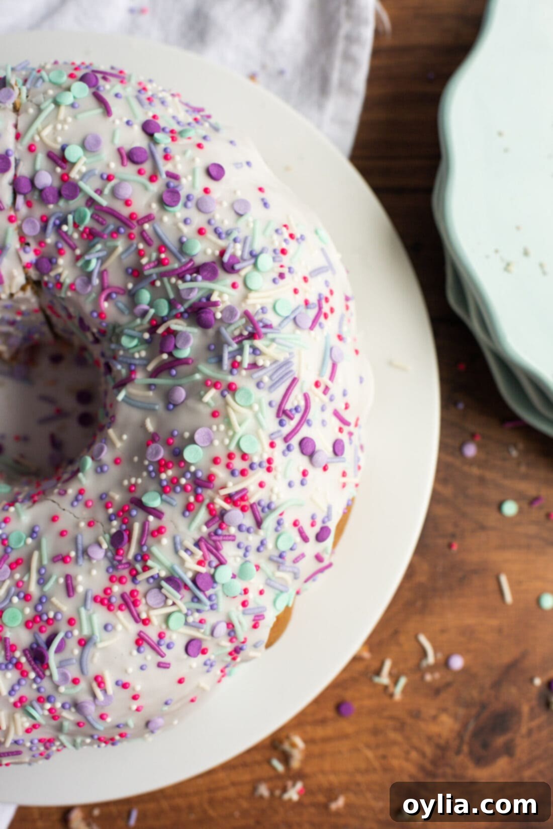 Overhead view of a beautiful Unicorn Bundt Cake with pastel swirls, vanilla glaze, and colorful sprinkles.